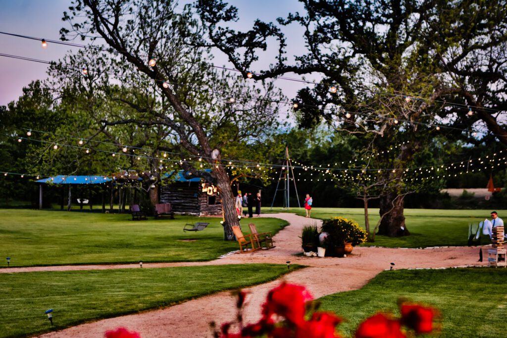 Wedding venue lawn with string lights and winding path
