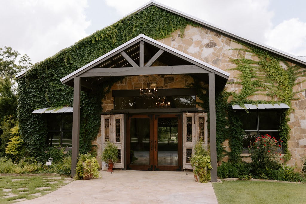 Rustic venue exterior with ivy-covered stone walls