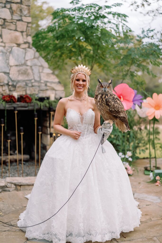 Bride in gown and crown holding owl