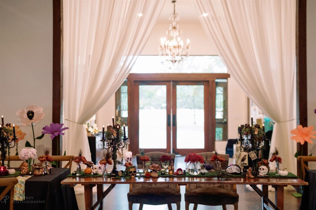 Halloween-themed head table with skull decor and candles