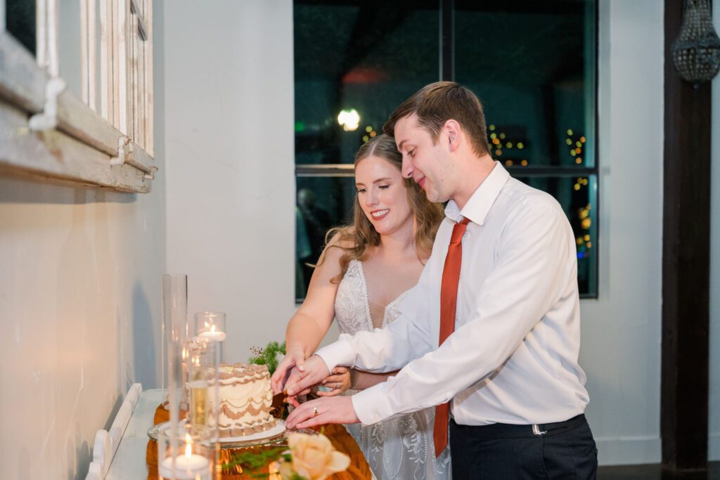 Newlyweds cutting their wedding cake