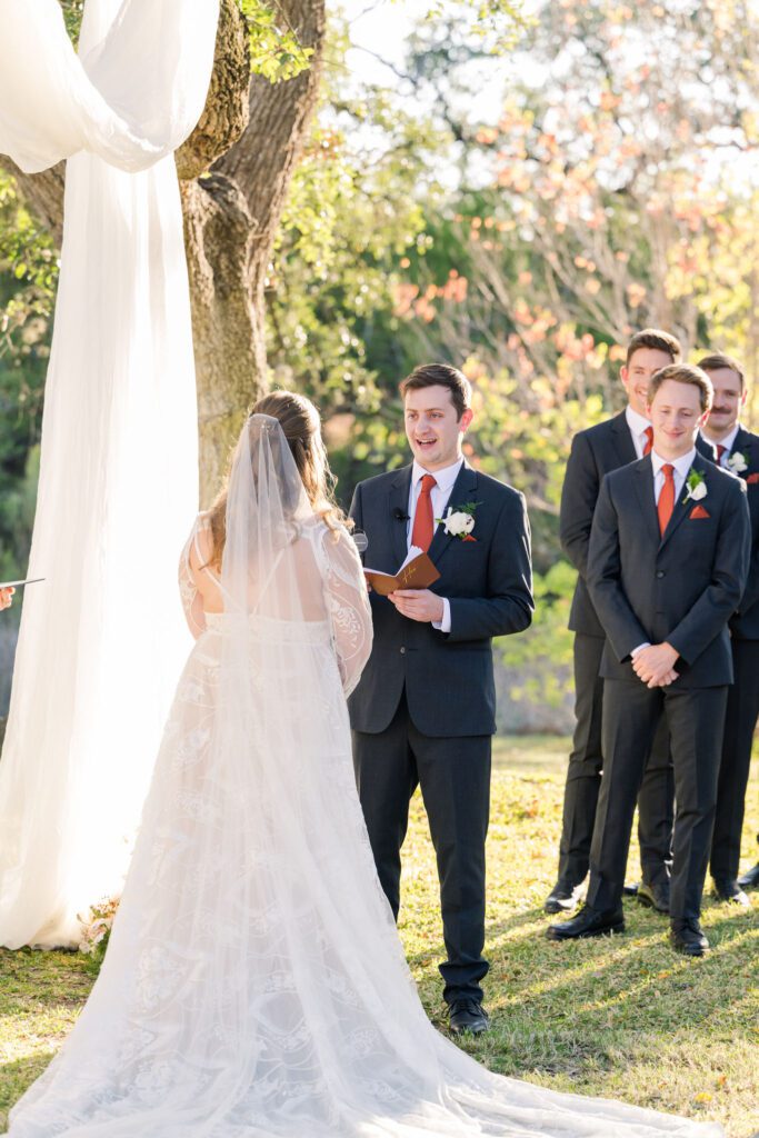 Groom reading his vows outdoors