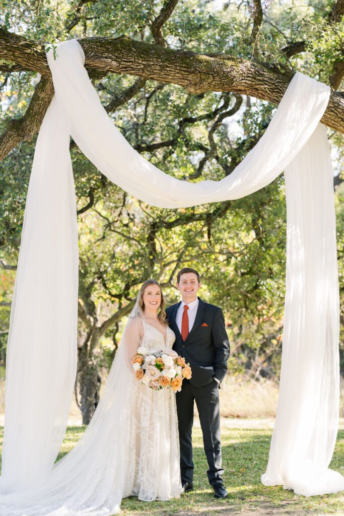 Bride and groom beneath a draped oak tree
